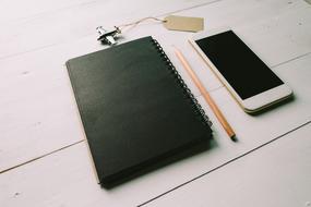 Black Notebook and Pencil