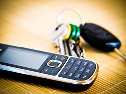 mobile push-button phone and keys on the keychain