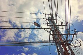Power lines and lantern on Utility Pole at sky