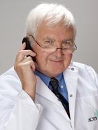elderly doctor with mobile phone