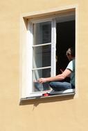 Person with Mobile Phone on Window