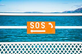 Sos Signs Telephone on fence