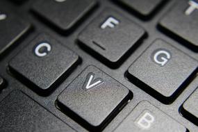 buttons on a black keyboard with letters