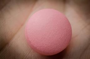Close-up of the pink tablet on the person's hand