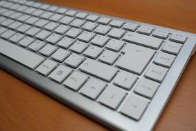 white keyboard with buttons on the table