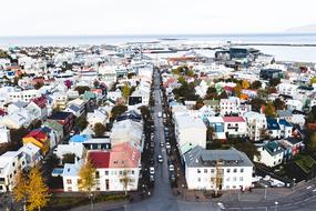 Beautiful cityscape with the colorful buildings and plants near the water