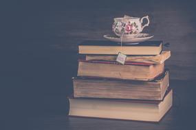 cup of tee on the pile of books