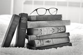 Stack Of vintage books and glasses