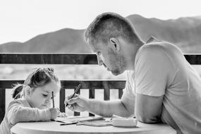 monochrome photo of dad and daughter painting