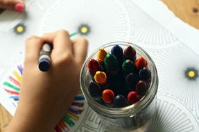 Crayons and Coloring Book and hand