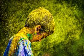 photo of an indian boy in multi-colored powder