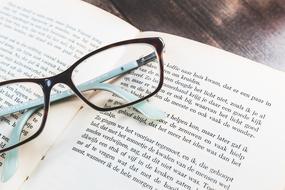 student glasses on a book