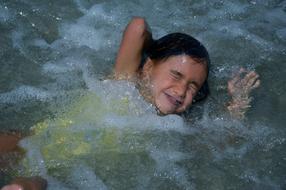 happy funny child Girl learning to swim