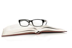 open book and glasses on white