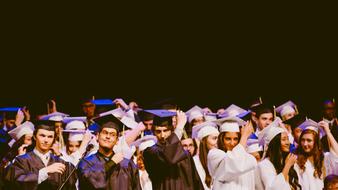 graduates in black and white suits