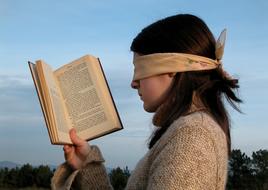 girl reads with closed eyes