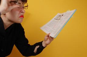 dissatisfied teacher reads a textbook