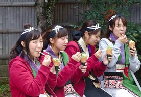 schoolgirls eat ice cream in Kyoto, Japan