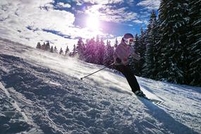 girl on a ski slope in bright sun rays