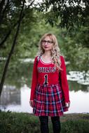 pretty girl in bulls 1 red clothing at pond