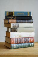 stack of old books on a wooden table