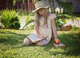 Child Girl in garden with book