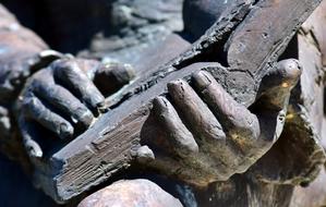 closeup picture of book in the hands of a bronze statue