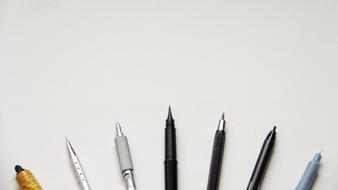 various pens on the white background