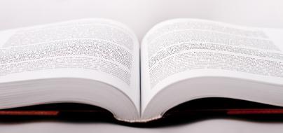 open book with text close up on blurred background