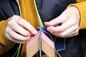 man is engaged in leather sewing