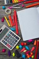 stationery, notebook, calculator and other colorful stuff on the table