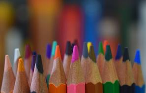 multicolored pencils close up on blurred background