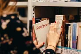 student takes a book in the library