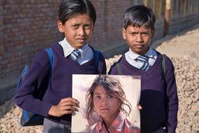 indian kids with portrait of a girl in hands