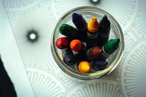 Crayons in jar on Coloring Book