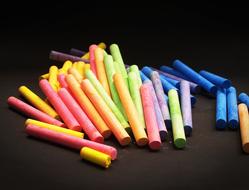 photo of multi-colored chalk on a black background