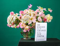 bouquet of fresh flowers and book on table