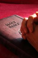male hands on Holy Bible