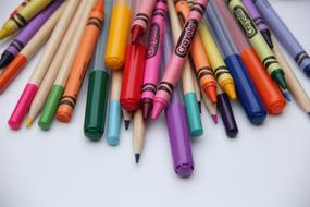 pencils, wax crayons and felt-tip pens on the table