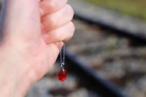 chain with a pendant in a child's hand