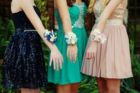 girls in colorful dresses with floral bracelets