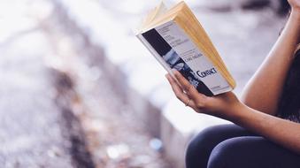 young Girl Reading book outdoor