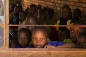 portrait of african schoolchildren look out the window