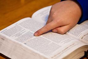 Bible Study, hand of child boy on holy book