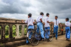 photo of schoolchildren with bicycles in India