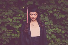 Graduation Masters woman and green bush