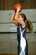 teenager girl in hands with a red basketball