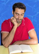 young man with a book at the table