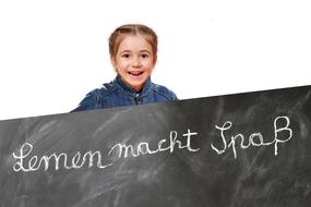 happy child girl behind black board