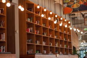glowing lamps in front of a bookcase